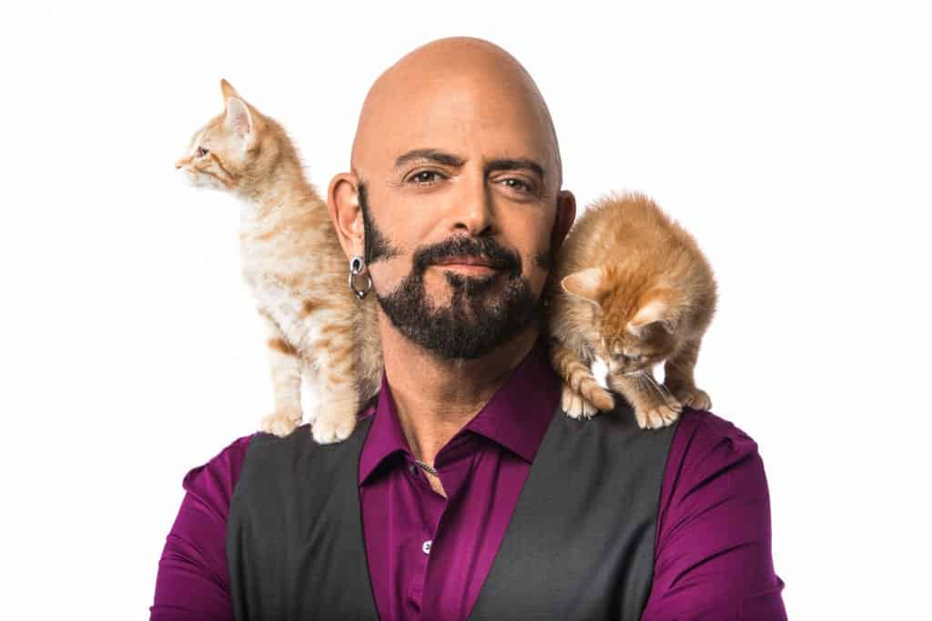 Jackson Galaxy with two kittens on his shoulder.