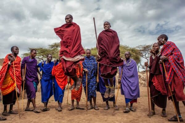 Young male Maasai dancing their traditional dance. Their main activity is raising cattle, but the Maasai have also been known for centuries as fearsome hunters and warriors.