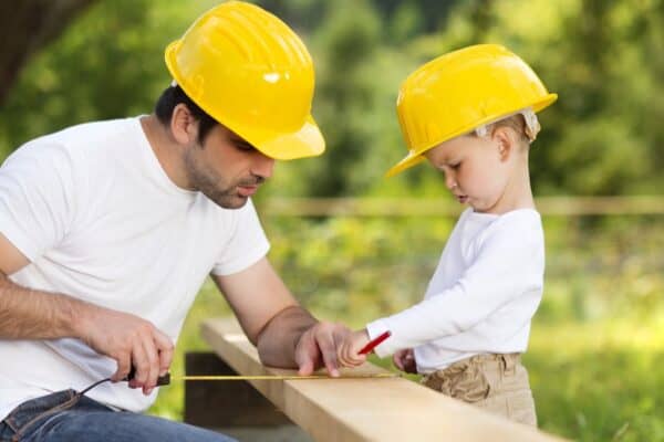Little son helping his father with building work. Humans not only have opposable thumbs, but we can use our thumbs and hands in ways that animals cannot. 