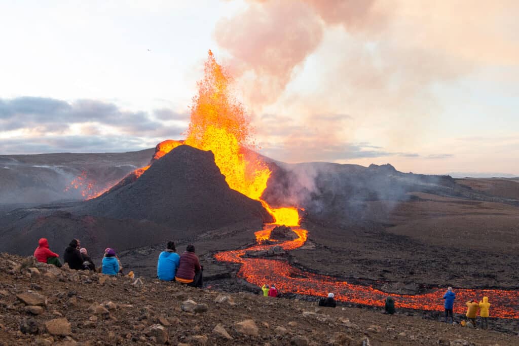 People watching a small volcano erupt in Iceland