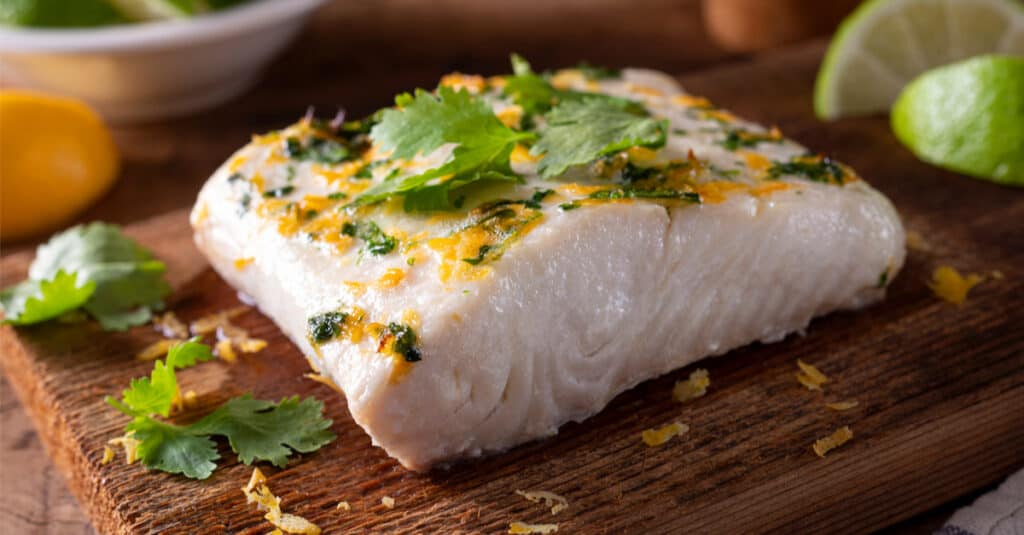 A piece of cedar-planked halibut with cilantro