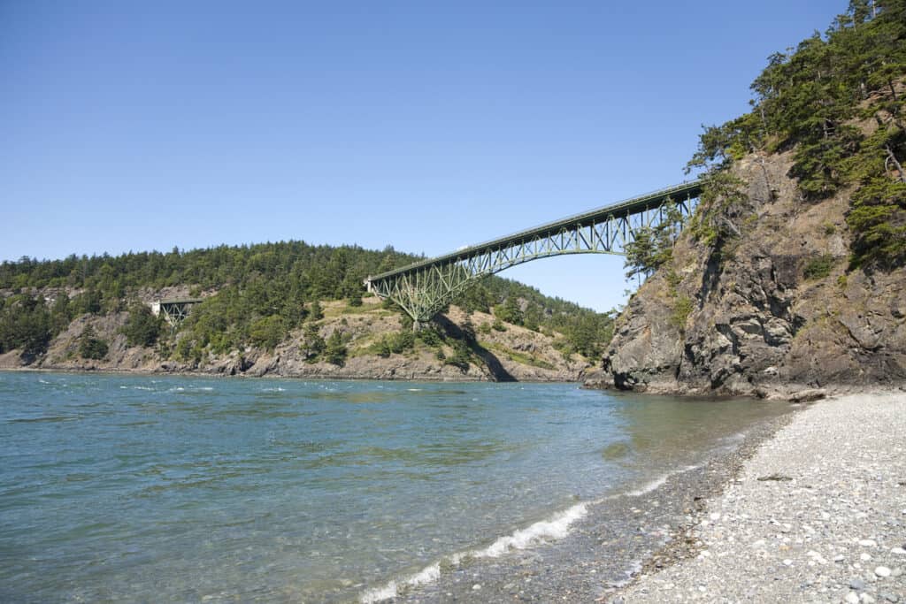 View of the Deception Pass Bridge from the beach below. Deception Pass is located at the north end of Whidbey Island in the state of Washington.