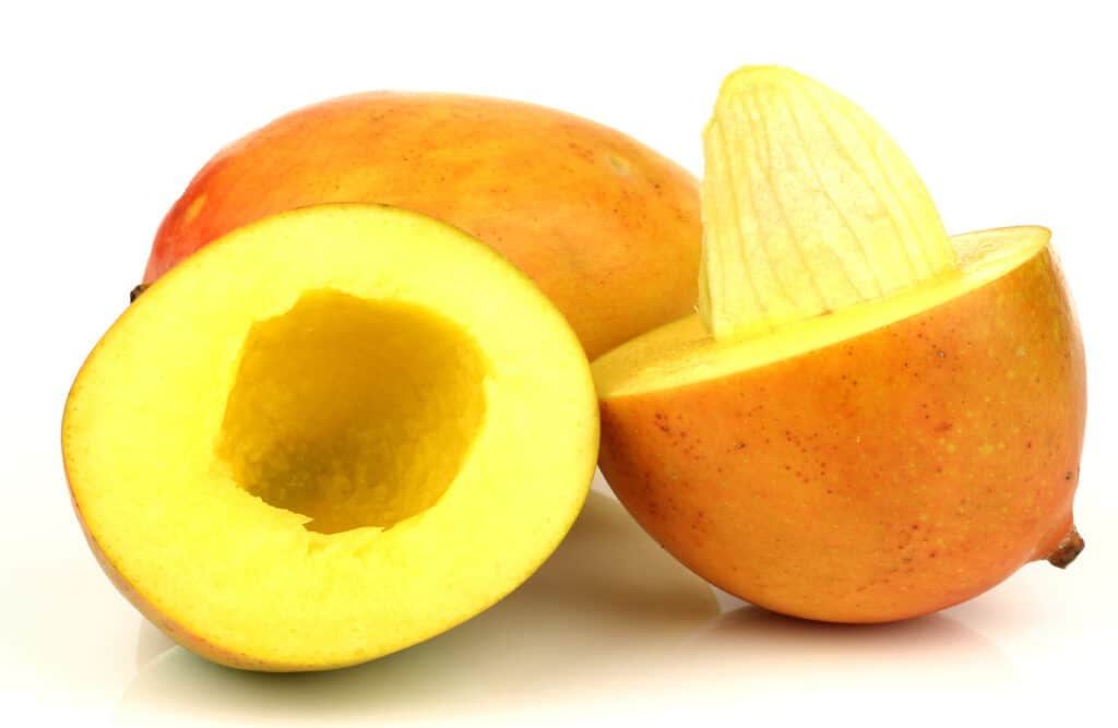 two mangos, one with with pit