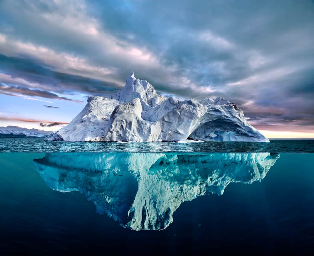 Iceberg,With,Above,And,Underwater,View,Taken,In,Greenland