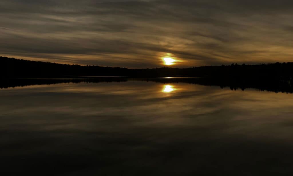 Sunset on the Otis Reservoir viewed from a dock.