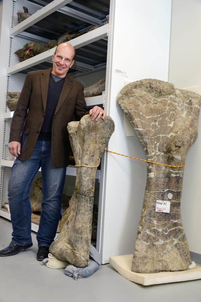 Dr. Kenneth J. Lacovara and the fibula (center) and humerus (right) of Dreadnoughtus schrani