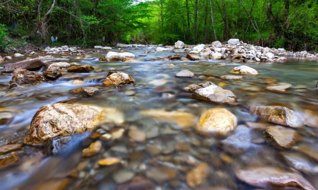 Rivers and streams A river and stream can be defined as. a natural