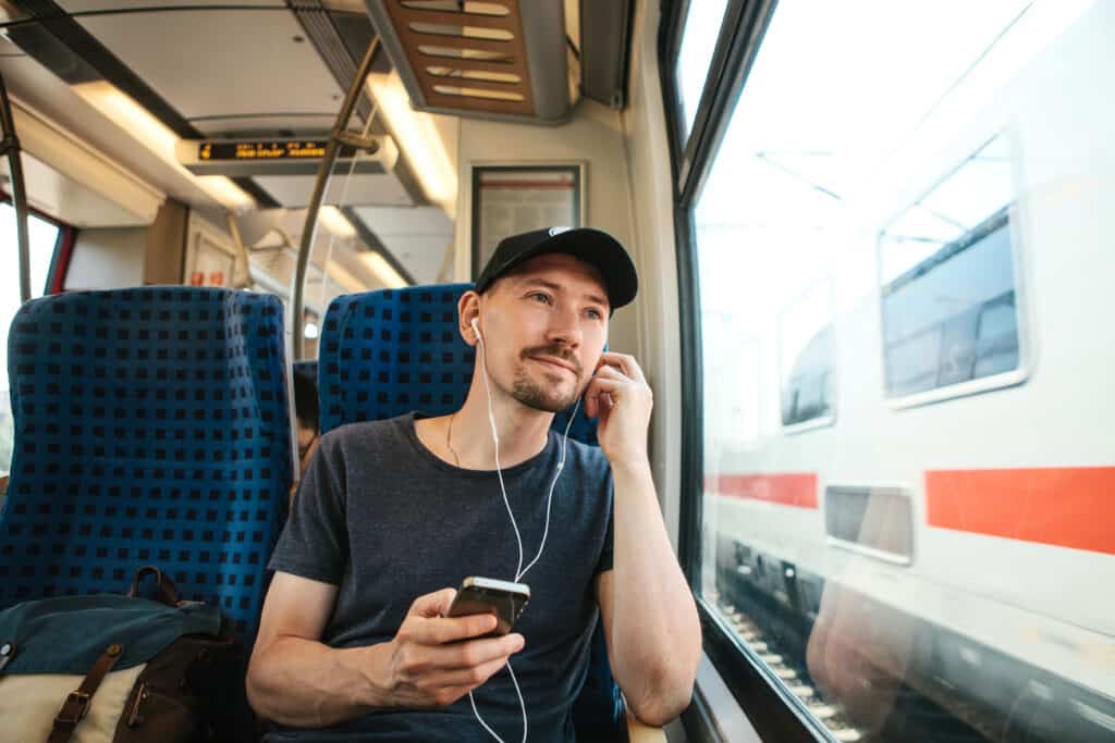guy on train listening to something