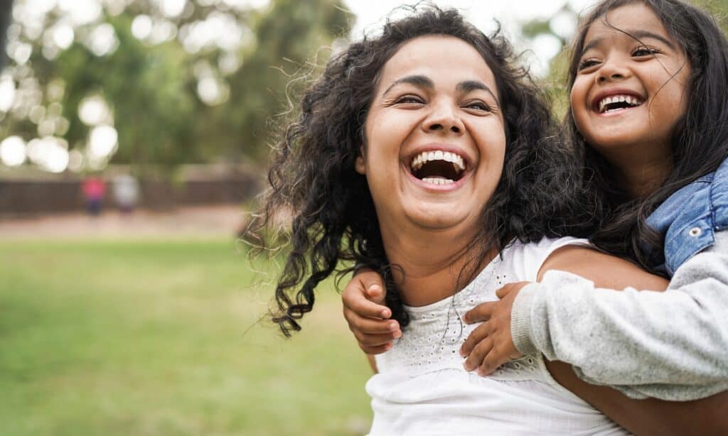 happy-indian-mother-having-fun-with-her-daughter-outdoor-family-and-picture-id1325578537