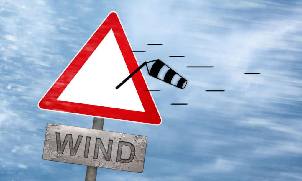 Wind warning sign getting blown away