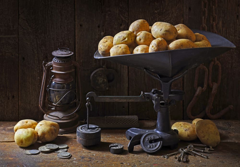 Still life with antique scale and potatoes