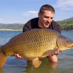man holding giant common carp