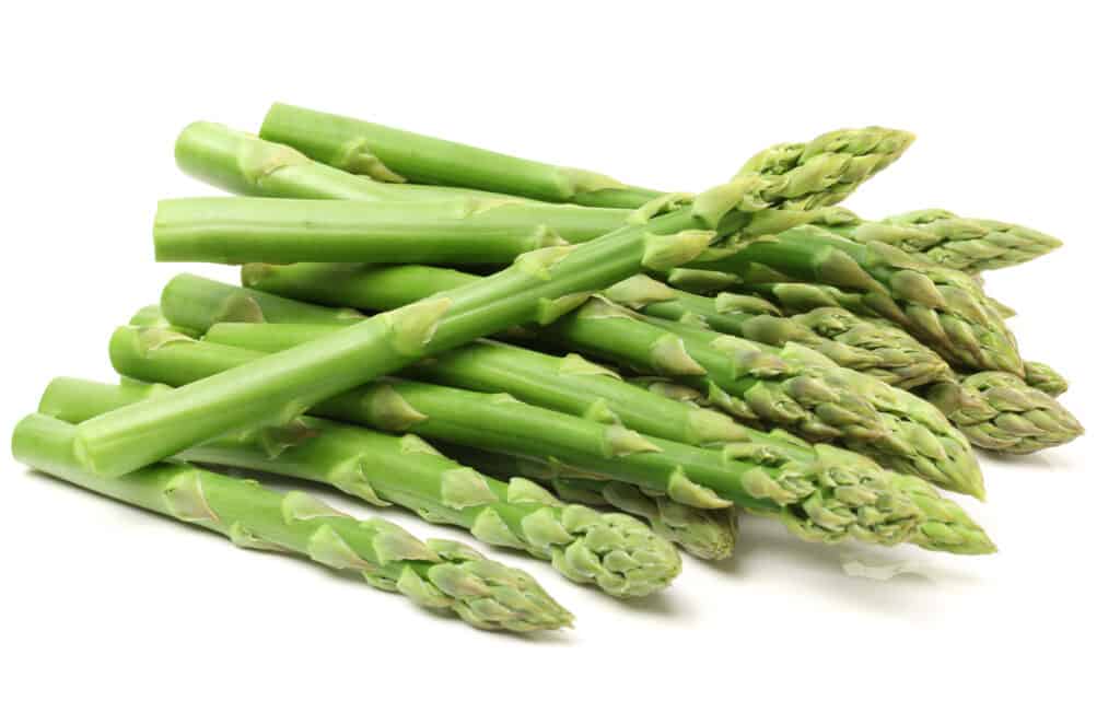 Asparagus stalks lying on a white background