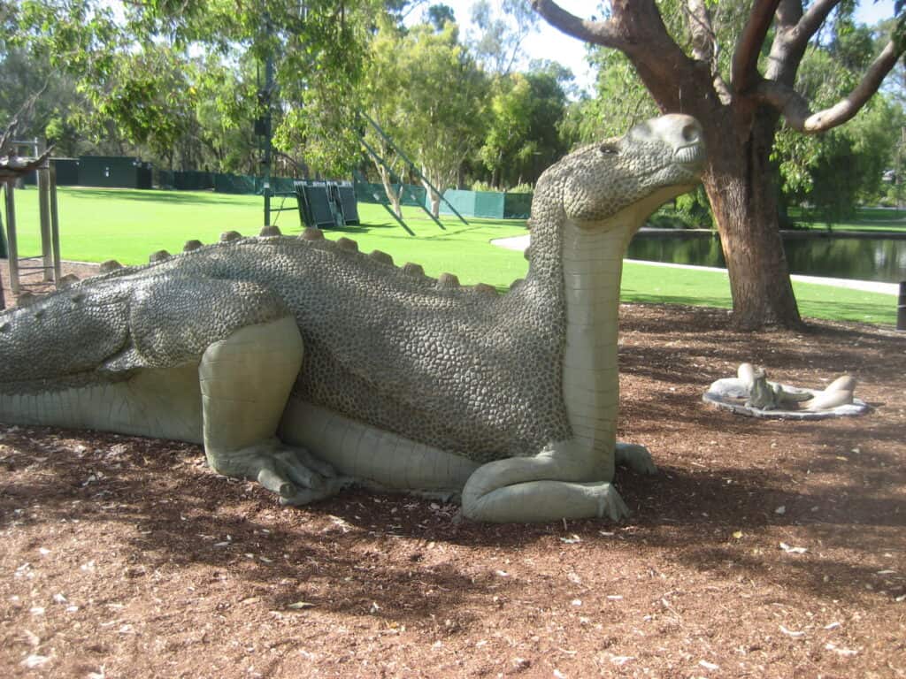 A lifelike replica of Muttaburrasaurus in a park