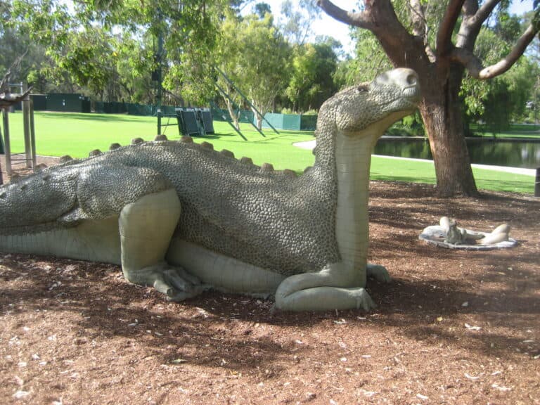 A lifelike replica of Muttaburrasaurus in a park