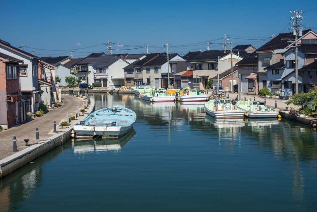 Imizu, Toyama, Japan – September, 21, 2021 – Small fishing harbour on the Hōjōzuuchi River in Hachiman town.