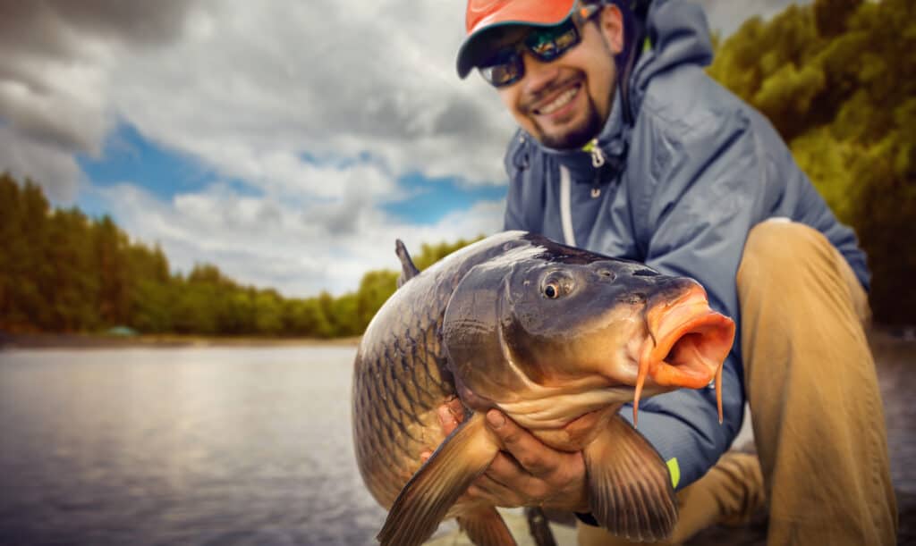 Fisherman holding a carp