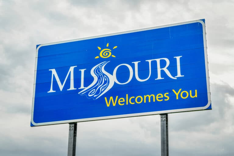 A Blue Street Sign Welcoming People to Missouri