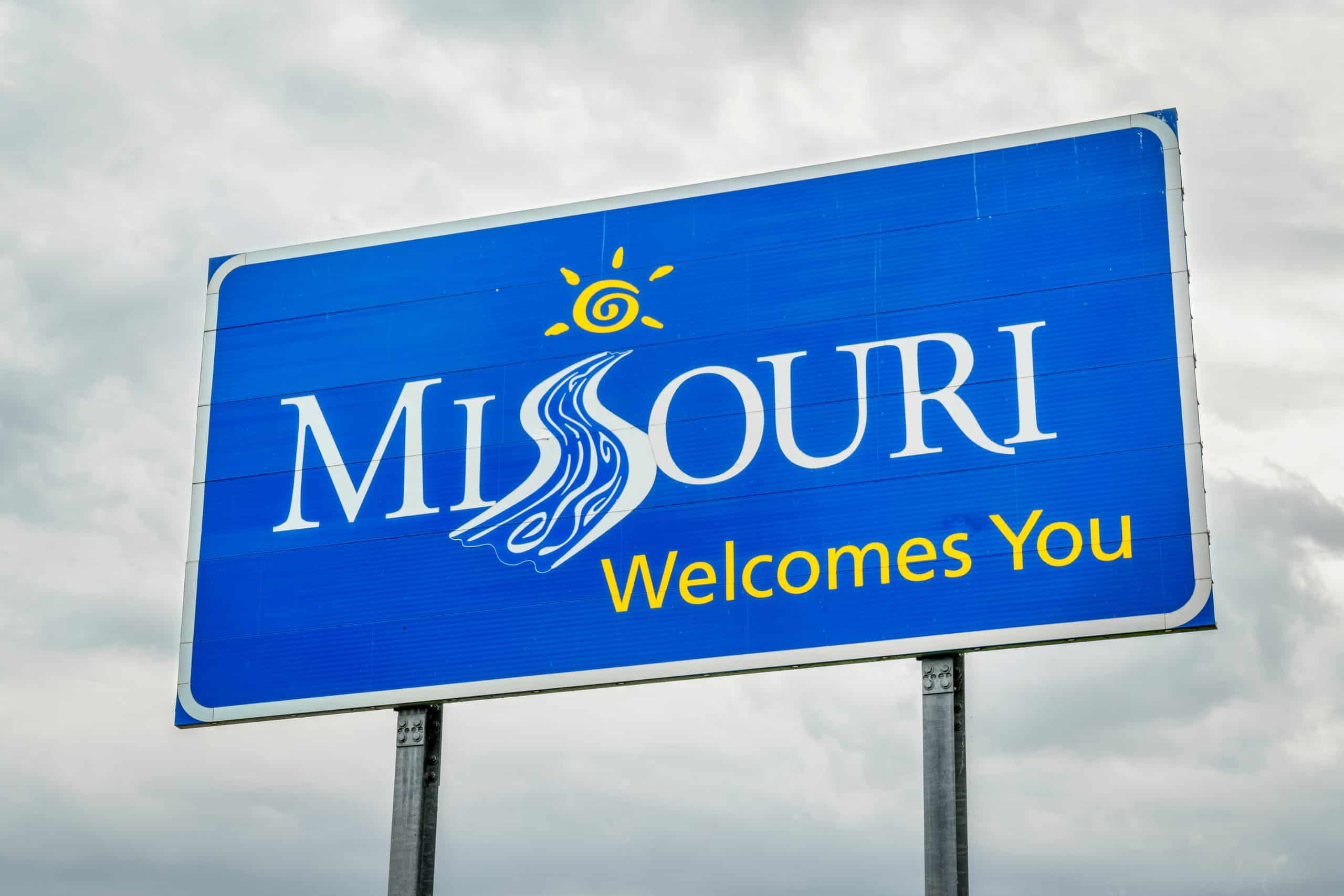 A Blue Street Sign Welcoming People to Missouri