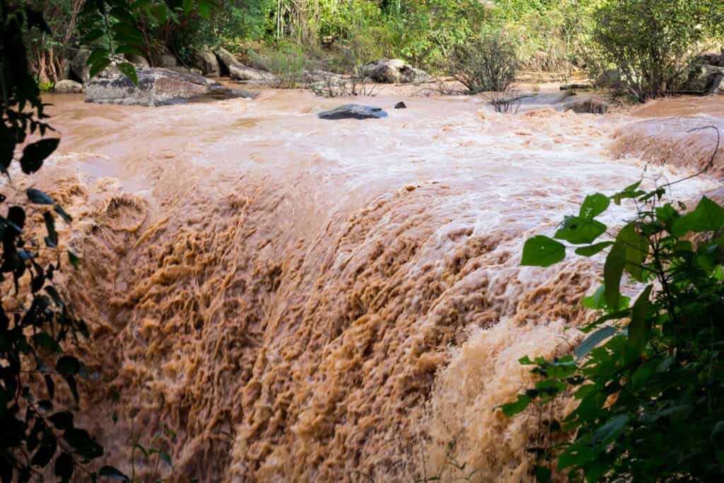 A waterfall of brown water caused by flash flooding