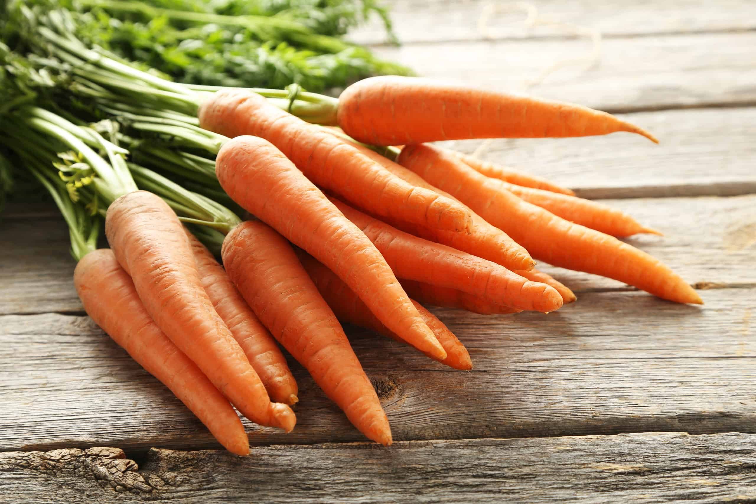 orange carrots on a wooden table