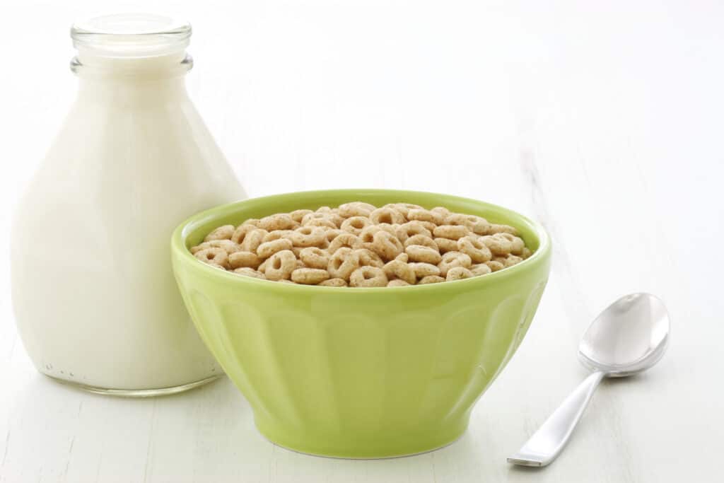 Can dogs eat Cheerios? Bowl of Cheerios and milk jug.