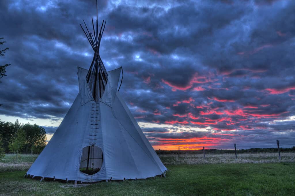 Traditional first nation Indian tipi under sunset at Rocky mountain house national historic site in Alberta, Canada
