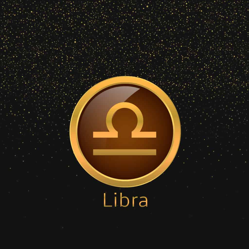 Gold Libra sign on black background