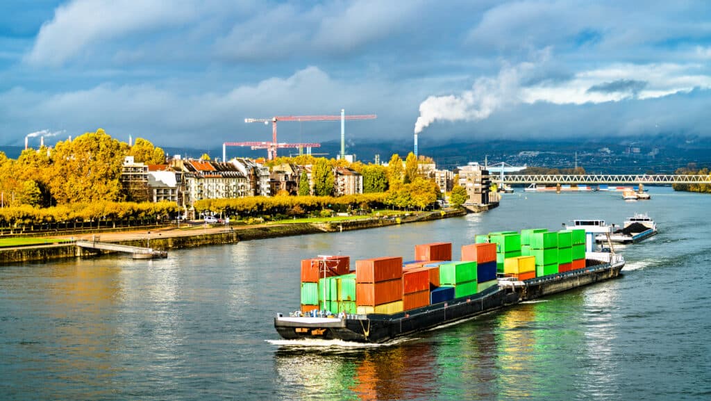 Container ship filled with brightly colored containers on the Rhine River in Mainz - Rhineland-Palatinate, Germany