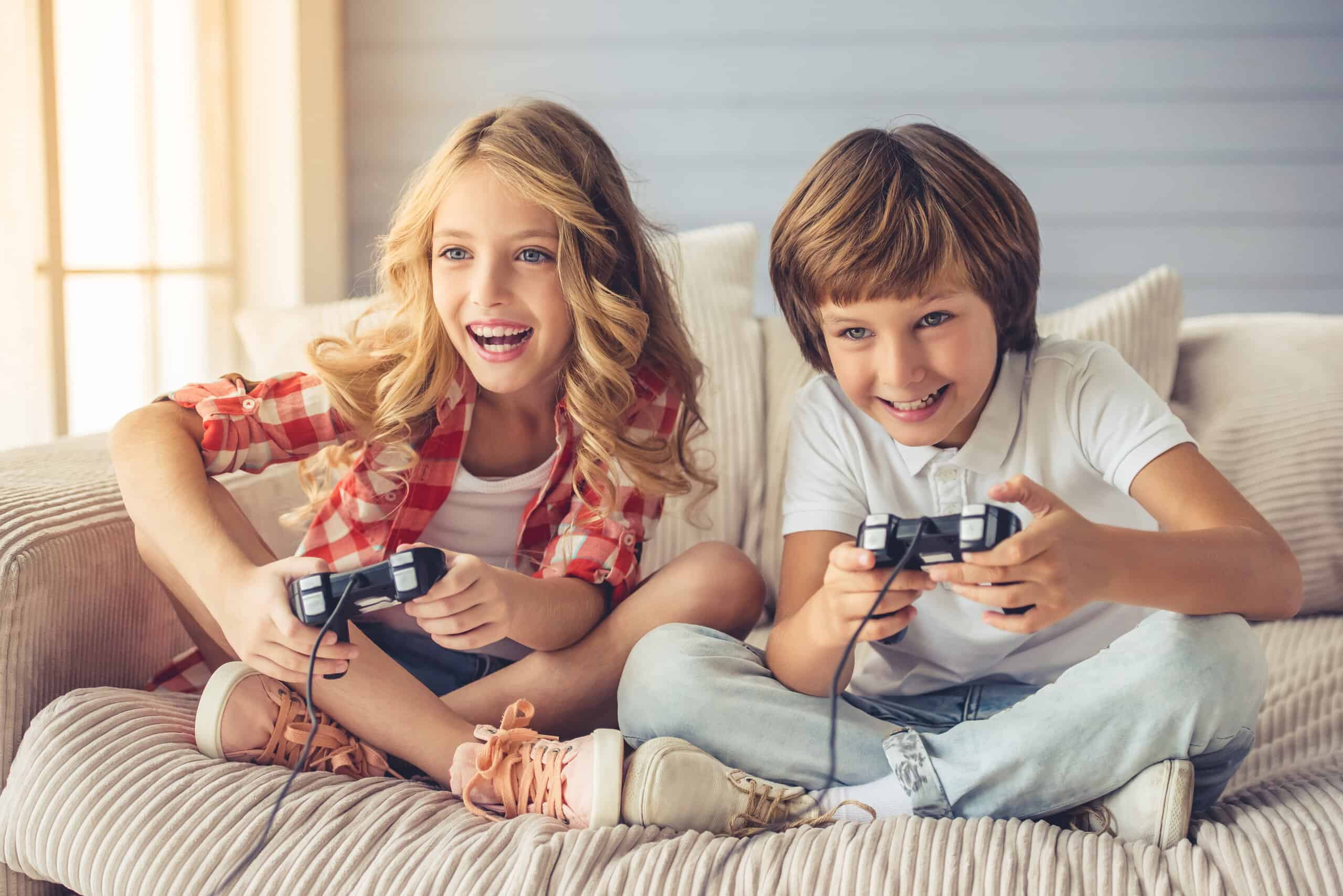 Girl and boy holding game remotes playing video game