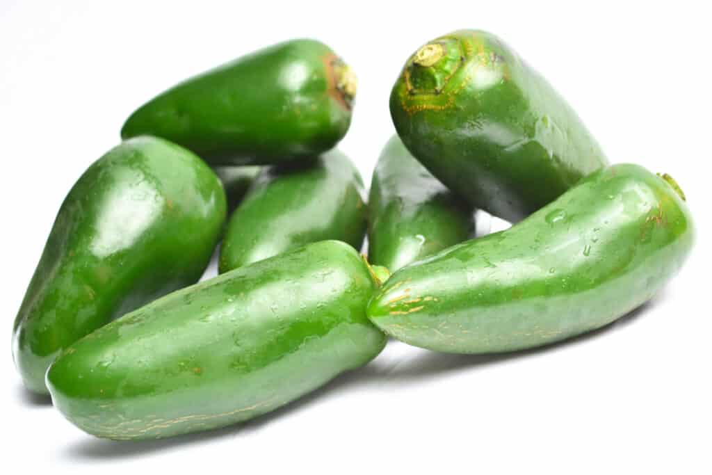 A pile of Jalapeno peppers isolated on white background.