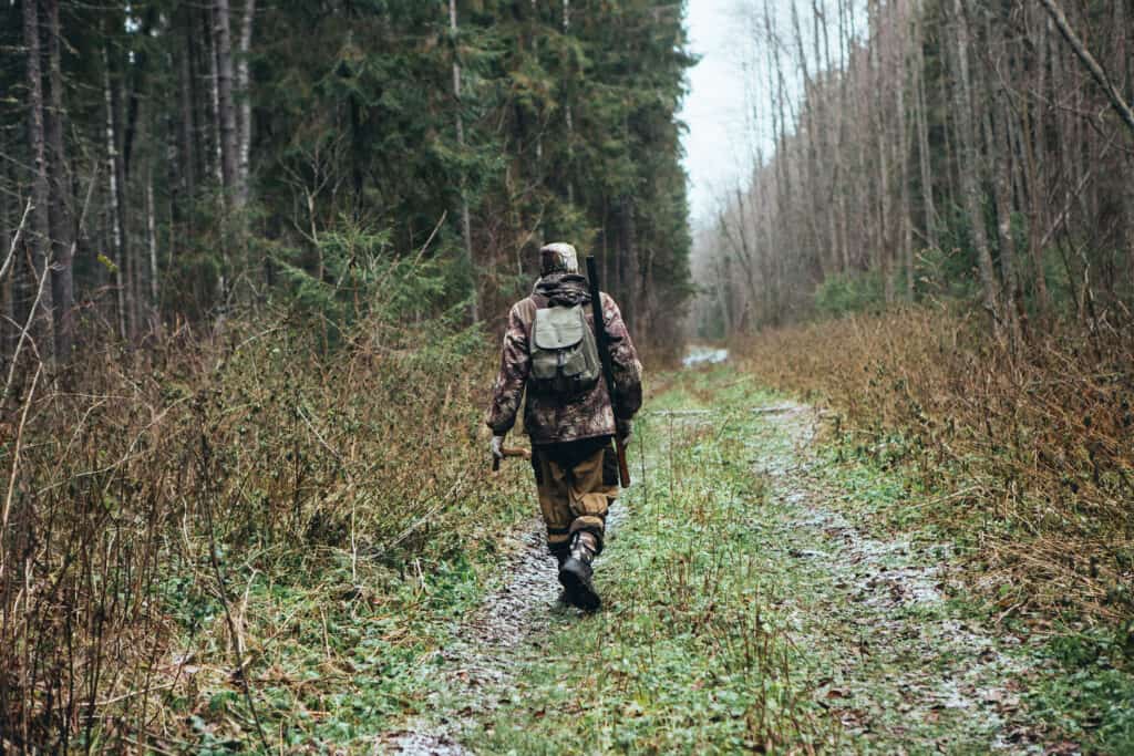 A hunter walking alone in the woods