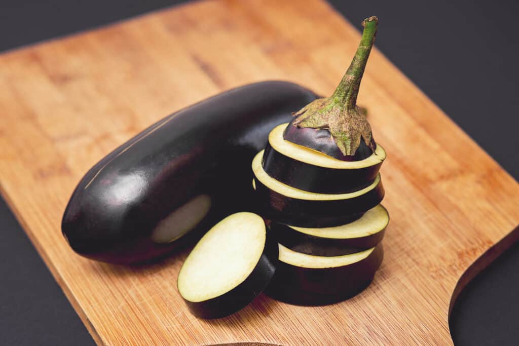 Fresh whole and sliced eggplants