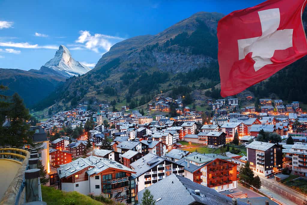 Zermatt village, Swiss alps, flag of Switzerland