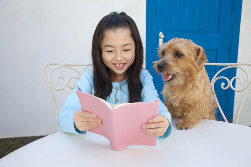 Girl reading to dog