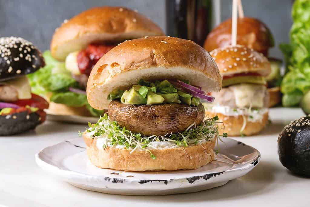 portobello "burgers" on buns with sprous and avocado
