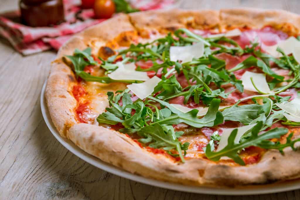 Fresh arugula topping a pizza