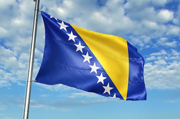 Bosnia and Herzegovina flag waves proudly.