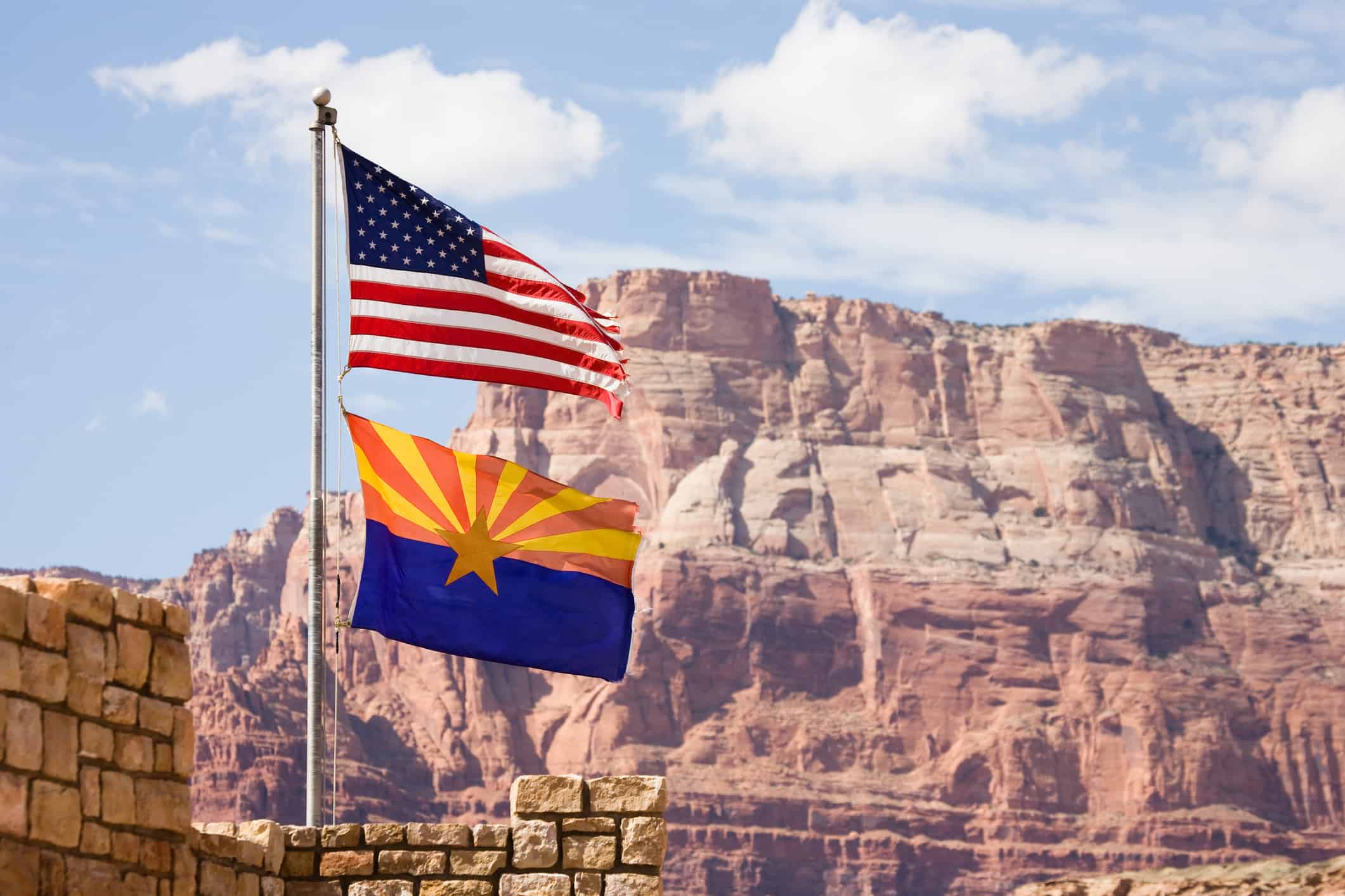 The flag of the United States of America flown above the Arizona state flag