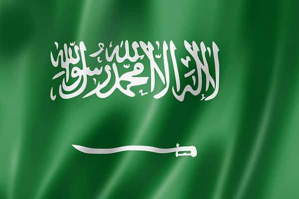 The Saudi flag features a white sword and text on a solid green background
