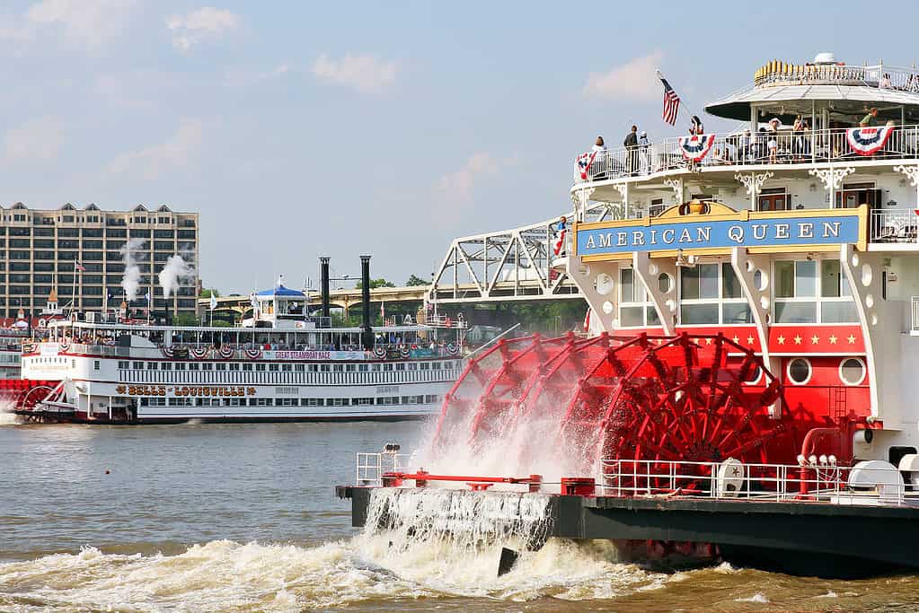 A steamboat travels down a river.