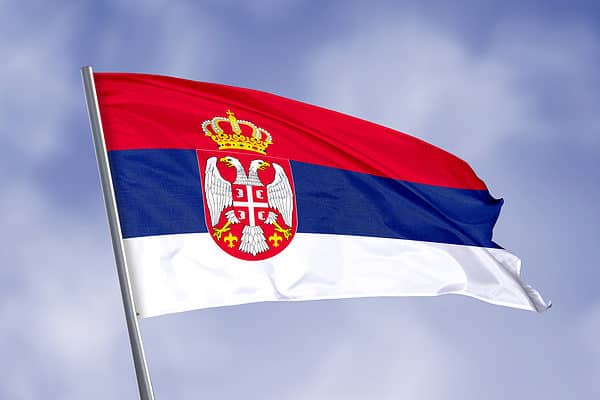Citizens of Serbia fly the nation's flag.