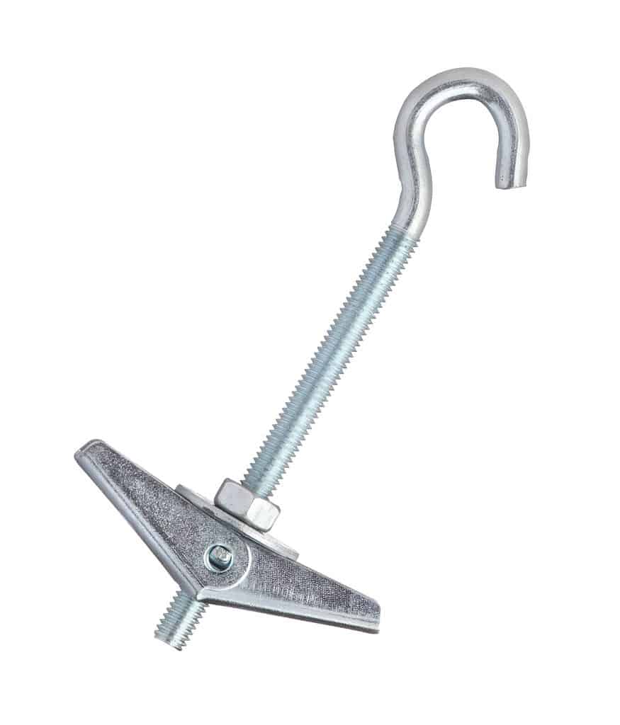 A photograph of a toggle bolt against white isolate the bolt is at a 45° angle with the hook and at approximately 1 o’clock and the toggle and at about 7 o’clock the bolt in the hook are silver metal.