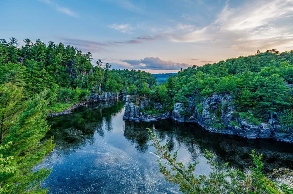 St. Croix River during sunset with colorful sky at Interstate State Park in St. Croix Falls Wisconsin. this is one of the best swimming holes in Wisconsin