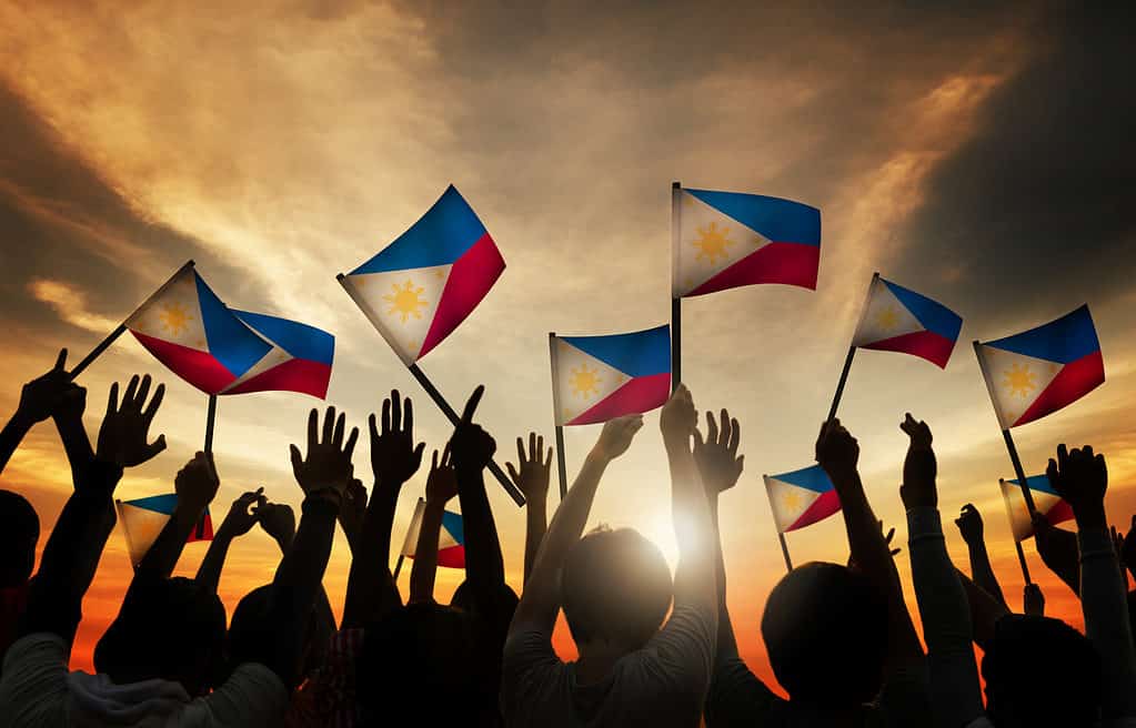 People waving flags of the Philippines