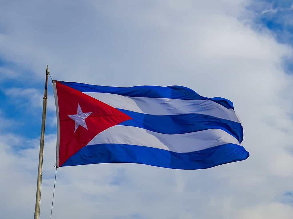 Cuba, Havana. Fortress wall and Cuban flag at San Carlos de