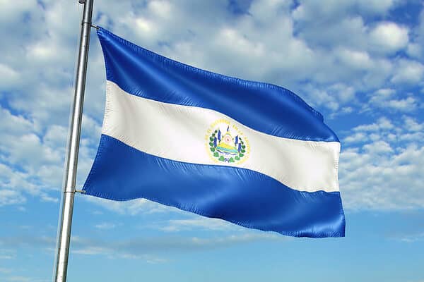 El Salvador flag on flagpole waving cloudy sky background realistic 3d illustration