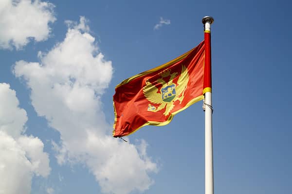 Flag of Montenegro against blue sky