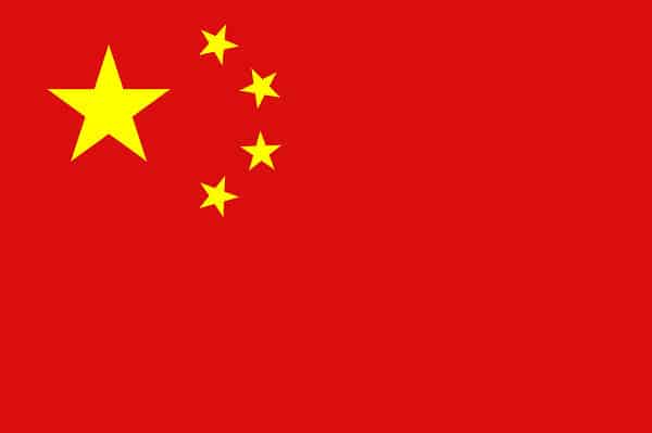 The Chinese flag has a red field with a big yellow star on the upper hoist-side and four smaller yellow stars, organized in a vertical arc toward the center of the flag. 
