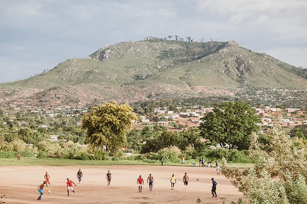 Young persons playing football in the outskirts of Blantyre, Malawi